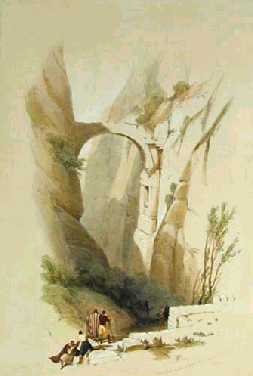 An old stone arch crosses a steep mountain ravine